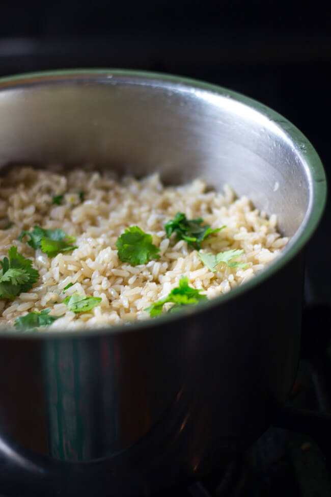 cilantro coconut brown rice is an awesome way to jazz but regular brown rice with the addition of lime, cilantro & coconut oil. Make this today!