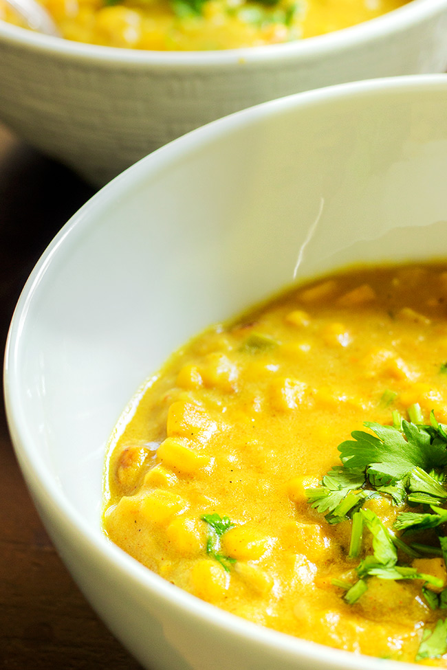 This curry corn chowder recipe is warming from the curry powder. It's made with fresh shaved corn that's roasted and cooked in the slow cooker until it is creamy. Make it today!
