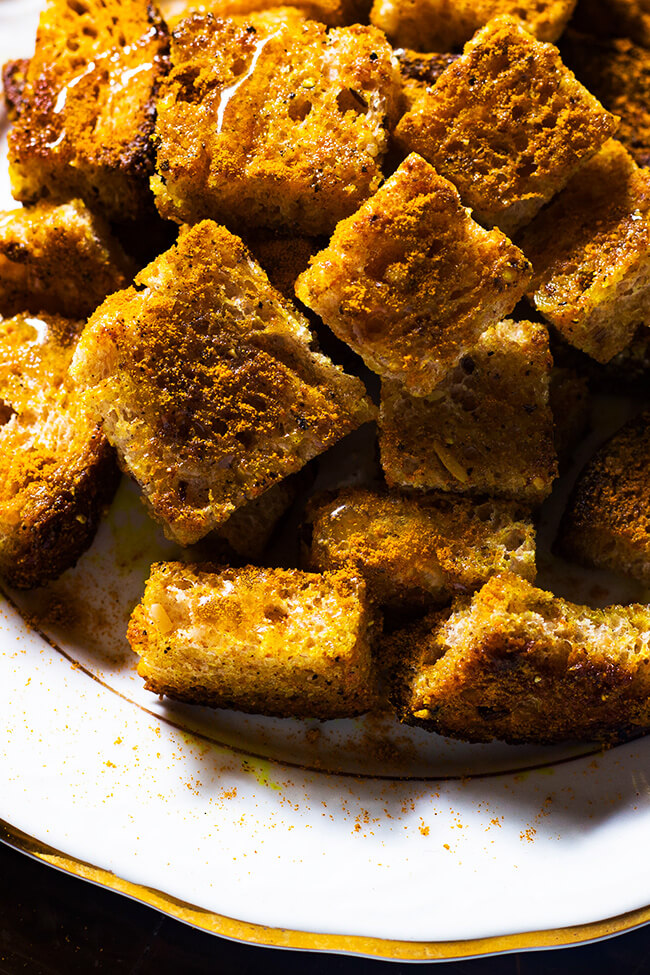This basic curry crouton recipe is the perfect addition to any salad or soup. What's not to love about bread, curry powder, honey and butter.
