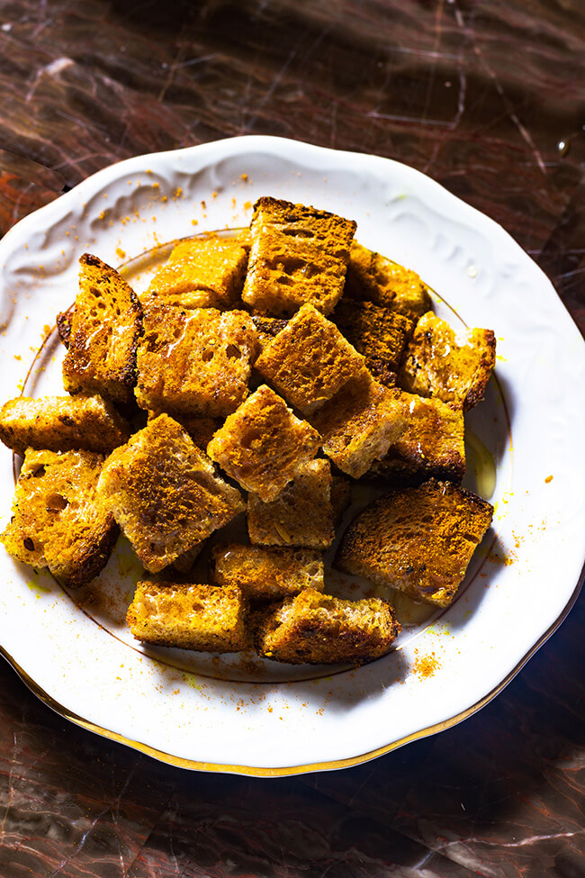 This basic curry crouton recipe is the perfect addition to any salad or soup. What's not to love about bread, curry powder, honey and butter.