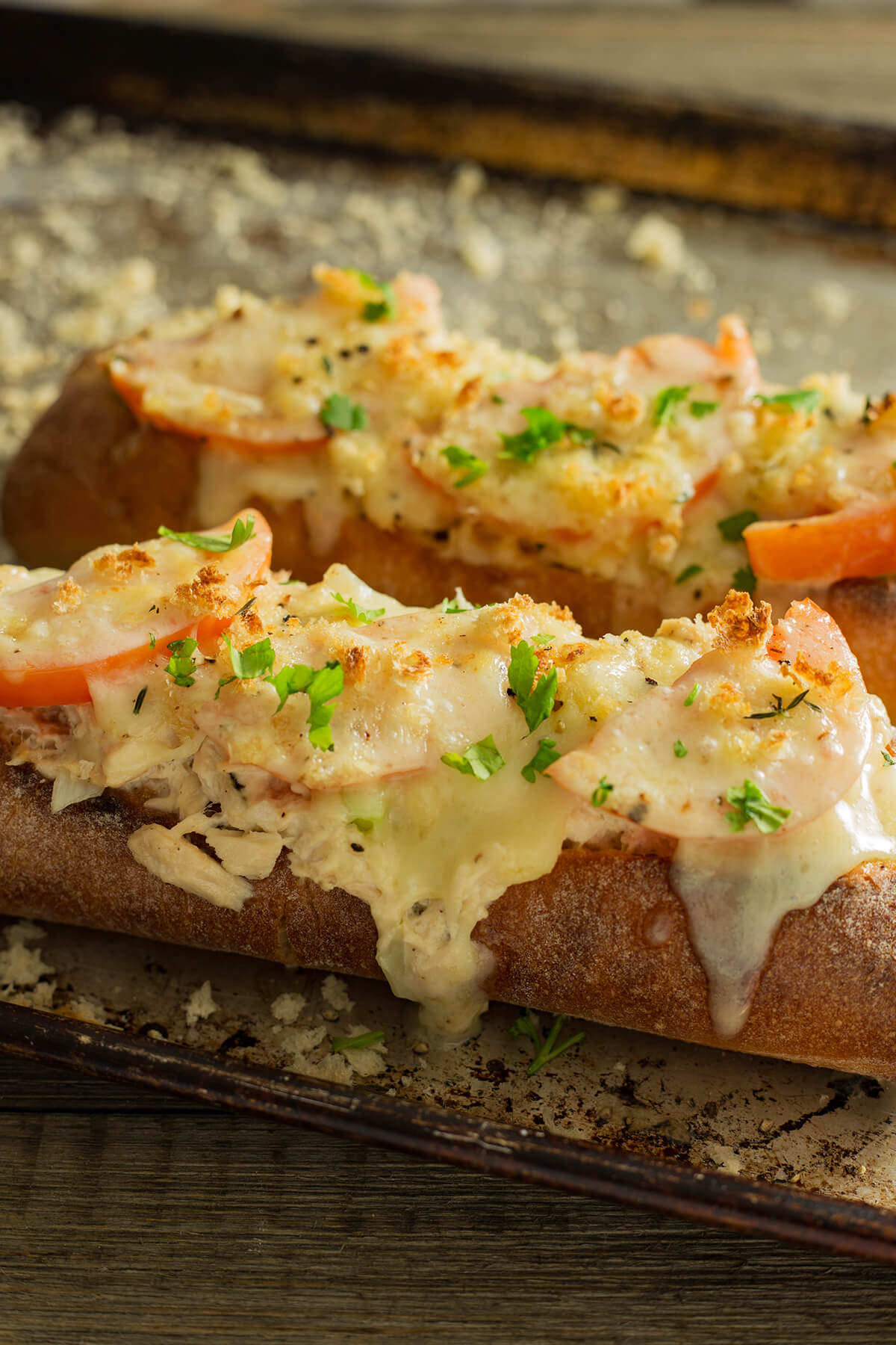 This cheesy Tuna Melt as a lunch or dinner entrée. This tuna melt is filled with creamy tuna salad topped with tomatoes and bubbling cheese that please a small or large crowd.